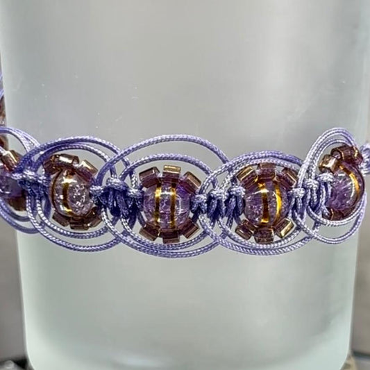 Woven bracelet featuring translucent purple beads