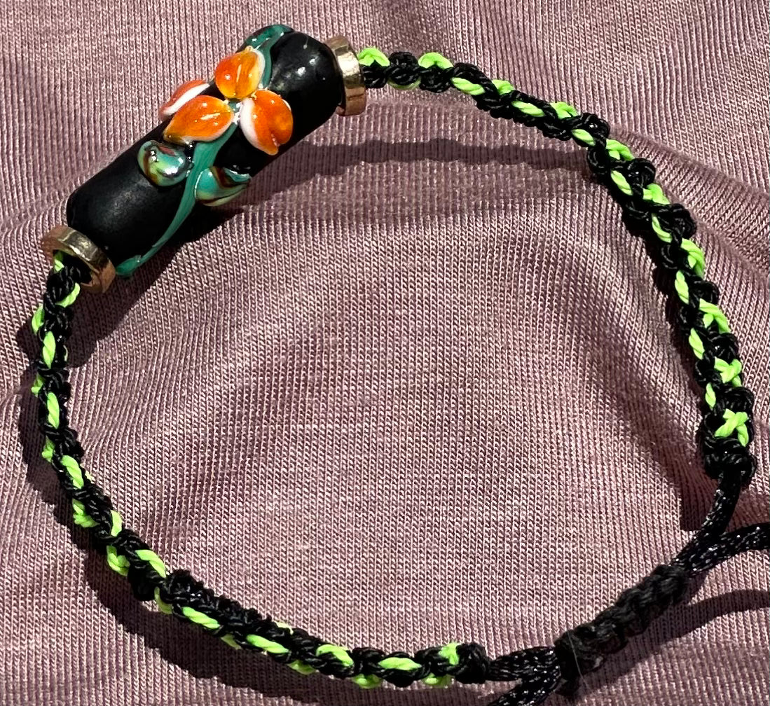 Orange flowers with a green & black cord