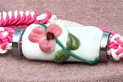 Pink flowers with a pink & white cord