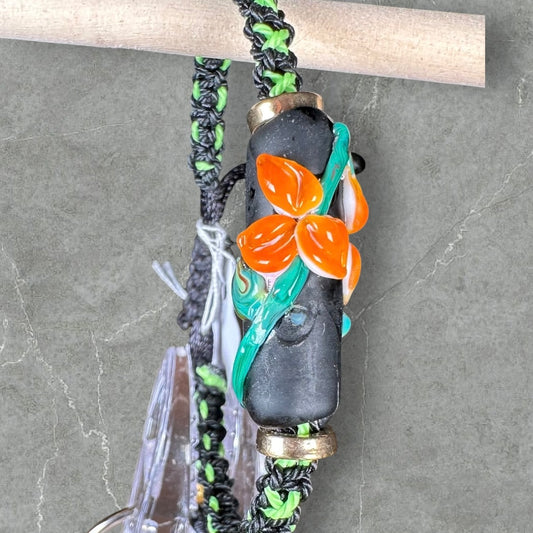 Orange flowers with a green & black cord
