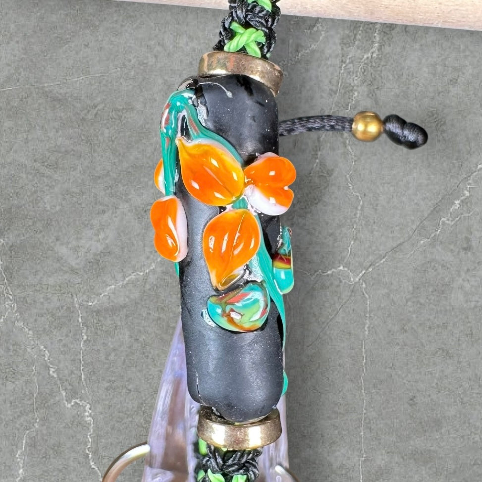 Orange flowers with a green & black cord
