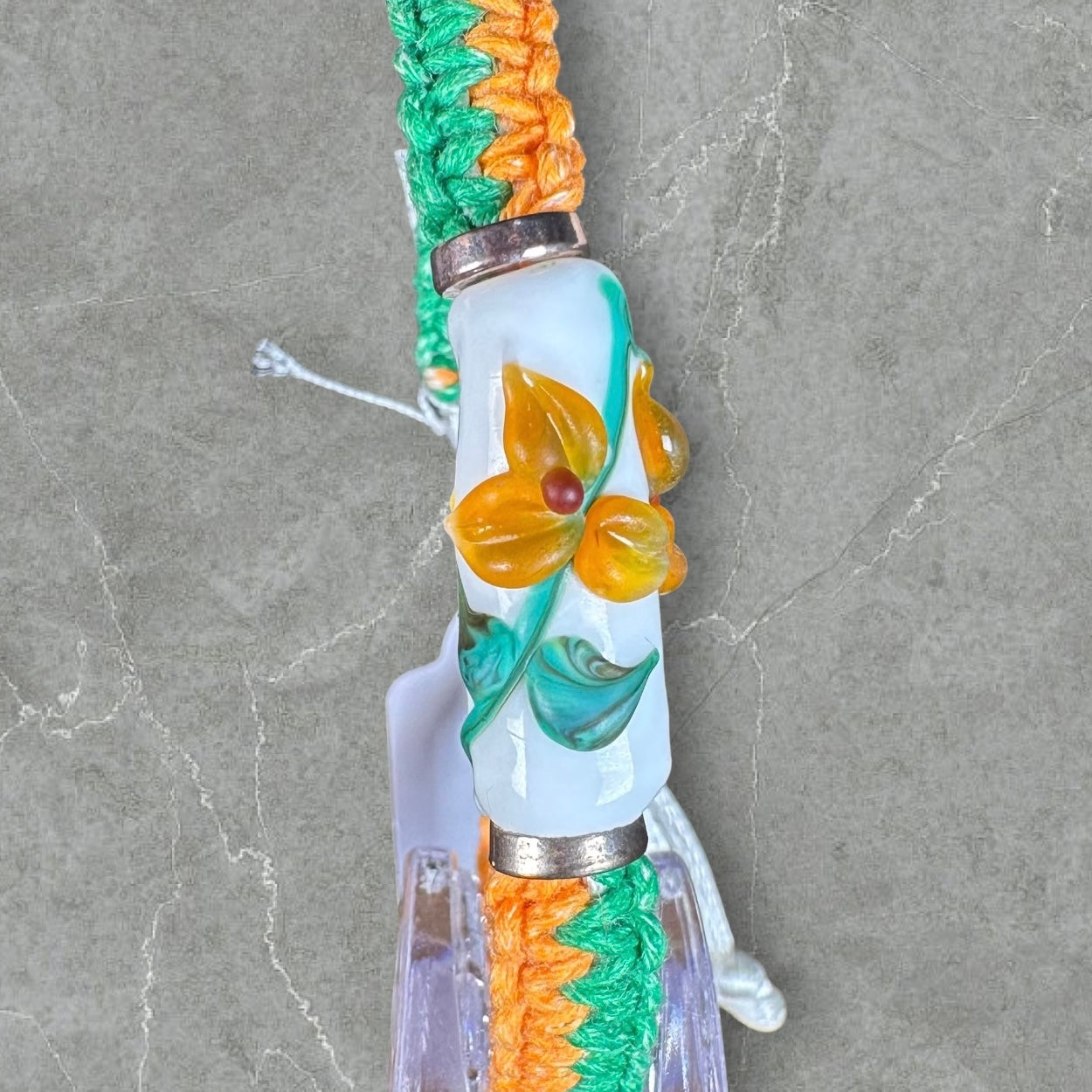 Orange flowers with a orange & green cord