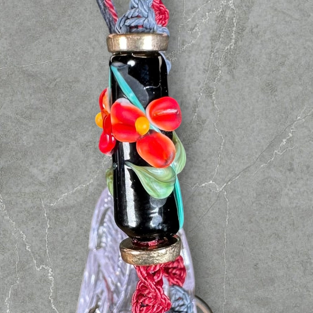 Red flower with maroon & gray cord