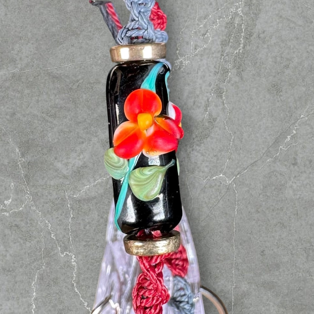 Red flower with maroon & gray cord