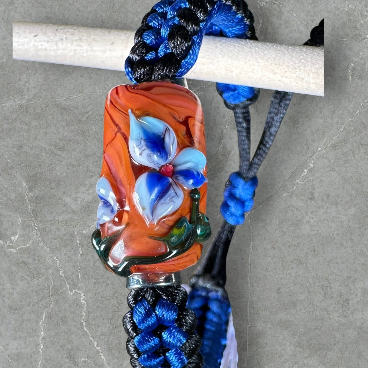 Stricking blue flowers on blue & black cord