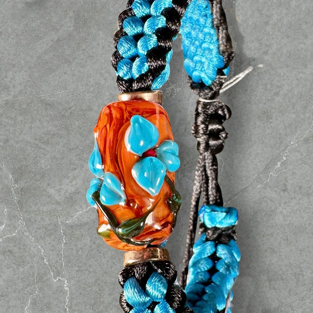 Sky blue flowers on blue & black cord